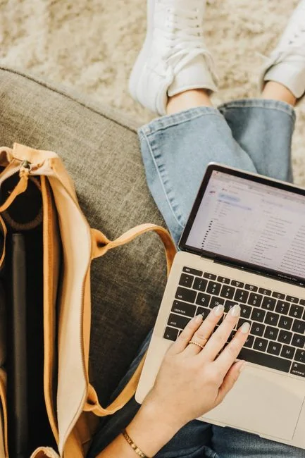 gallery-1 Business professionals analyzing stock charts and graphs on a laptop in an office setting.